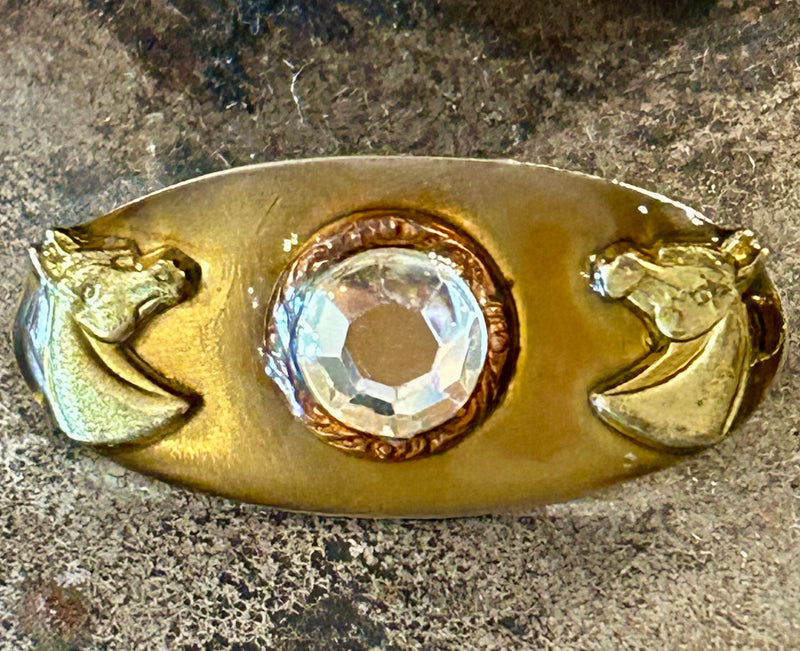 Vintage gold tone brooch depicting two horse heads with  a paste center stone 1/2” x 1” *