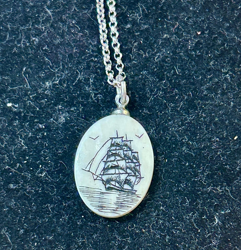 Vintage Clipper ship pendant featuring a detailed maritime scene etched on to scrimshaw on a 18 inch sterling silver chain