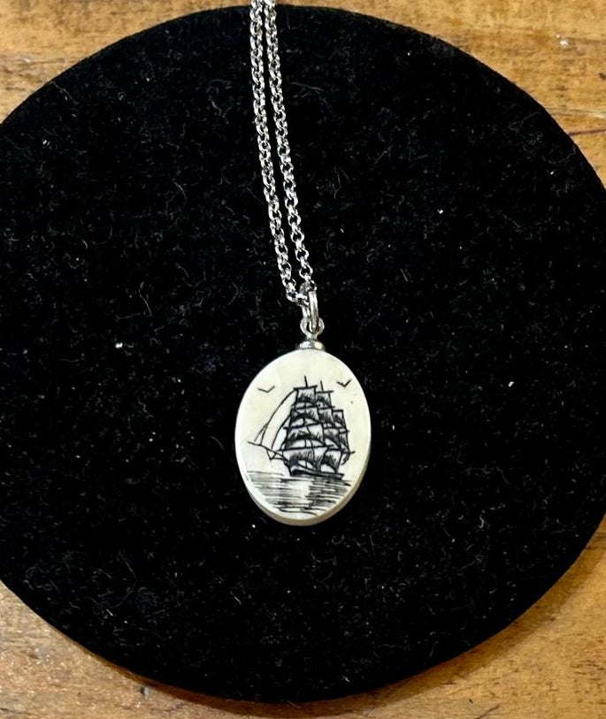 Vintage Clipper ship pendant featuring a detailed maritime scene etched on to scrimshaw on a 18 inch sterling silver chain