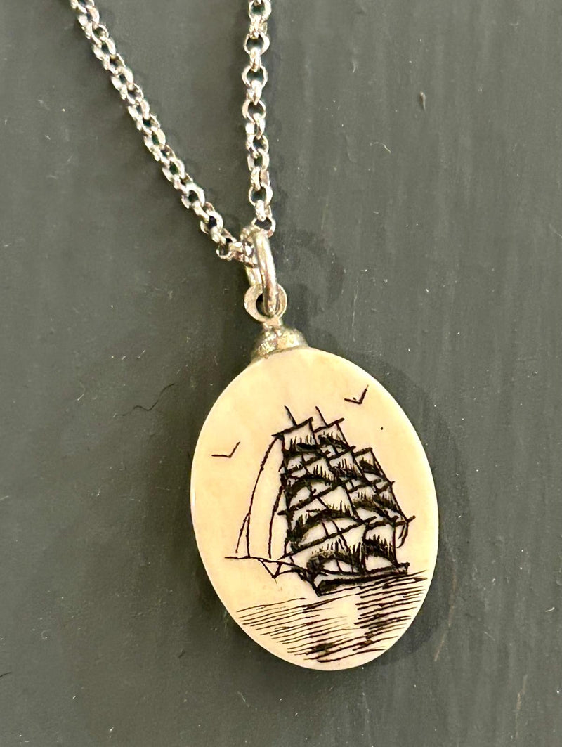 Vintage Clipper ship pendant featuring a detailed maritime scene etched on to scrimshaw on a 18 inch sterling silver chain