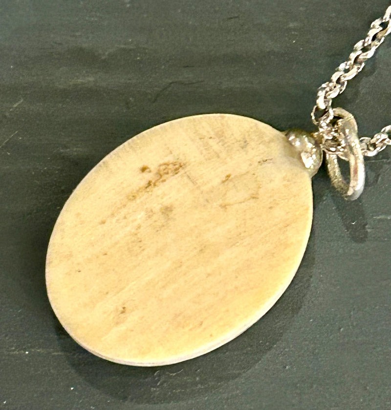 Vintage Clipper ship pendant featuring a detailed maritime scene etched on to scrimshaw on a 18 inch sterling silver chain