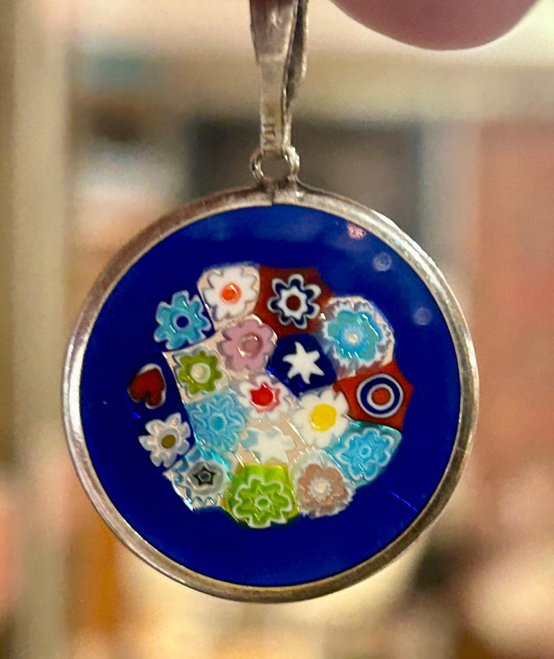 Vintage Sterling Silver Millefiori pendant on a 18 inch sterling silver chain; with a royal blue glass background, made in italy
