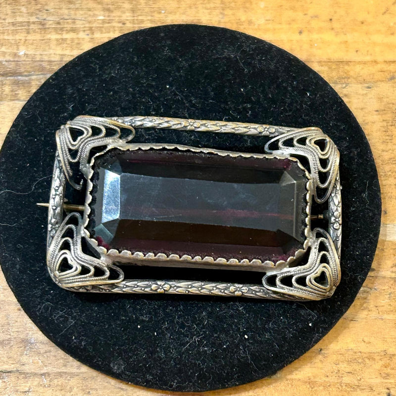 Vintage open work filigree Brooch with large rectangular emerald cut purple glass