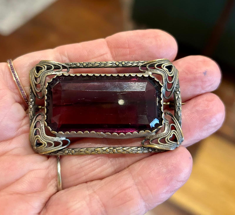 Vintage open work filigree Brooch with large rectangular emerald cut purple glass