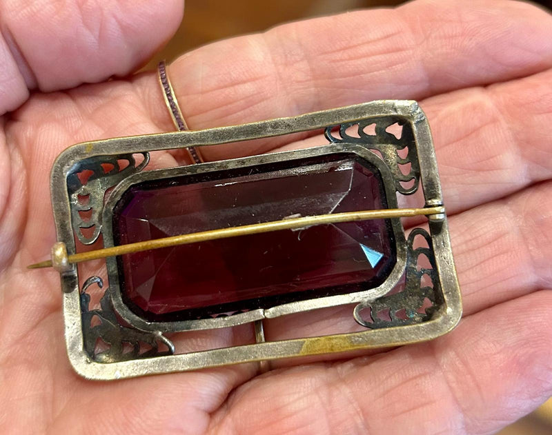Vintage open work filigree Brooch with large rectangular emerald cut purple glass