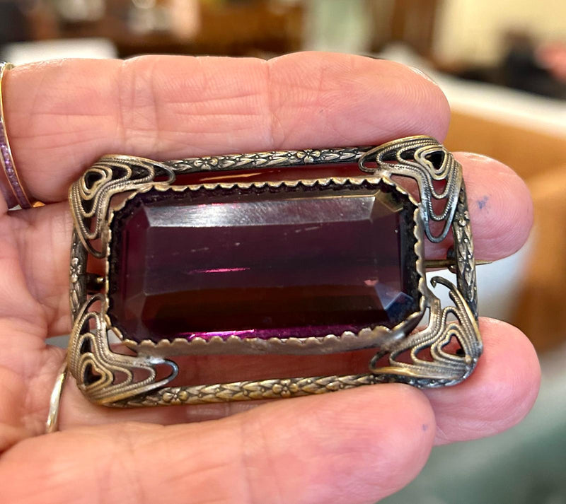 Vintage open work filigree Brooch with large rectangular emerald cut purple glass